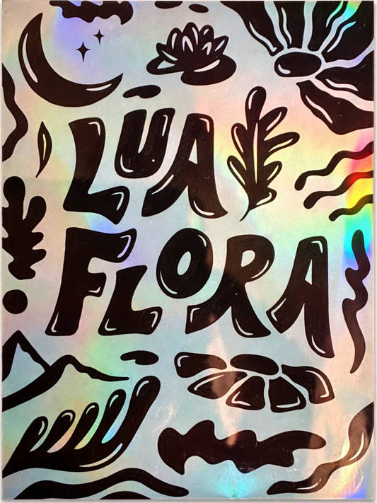 Holographic sticker with 'Lua Flora' text and floral designs on a white background